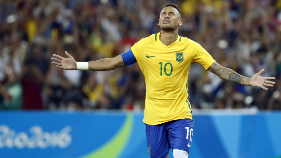 Brazil's forward Neymar celebrates scoring the winning goal during the penalty shoot-out of the Rio 2016 Olympic Games men's football gold medal match between Brazil and Germany at the Maracana stadium in Rio de Janeiro on August 20, 2016. / AFP / Odd Andersen (Photo credit should read ODD ANDERSEN/AFP/Getty Images)