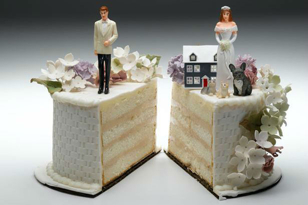 Bride-and-groom-figurines-standing-on-two-separated-slices-of-wedding-cake-w900-h600