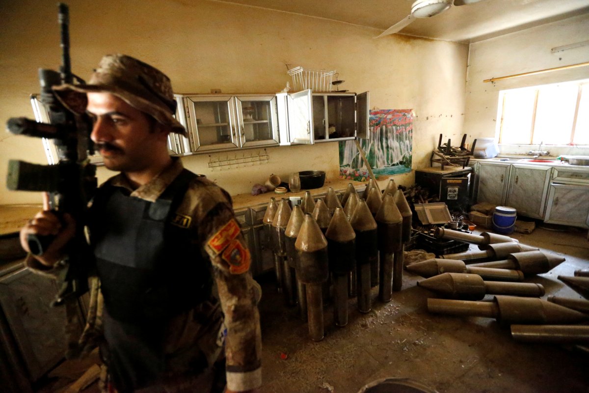 a-member-of-the-iraqi-counterterrorism-force-stands-by-an-isis-factory-in-fallujah