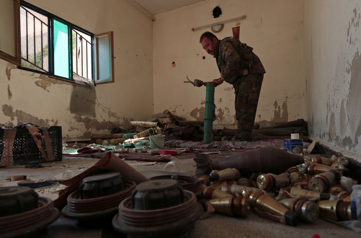 a-syria-democratic-forces-fighter-inspects-a-room-that-according-to-the-sdf-was-used-by-isis-militants-to-prepare-explosives-in-manbij