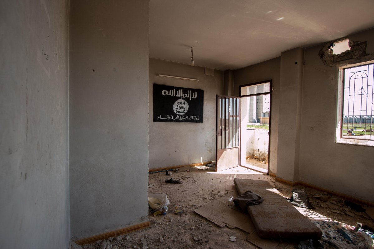 an-isis-flag-hangs-on-the-wall-of-an-abandoned-building-in-tell-hamis-syria-after-the-kurdish-peoples-protection-units-or-ypg-took-control-of-the-area-from-isis-militants