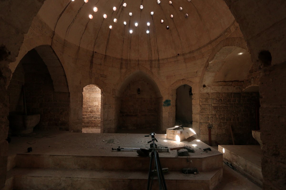 tripods-and-a-projector-inside-an-ancient-hammam-or-steam-bath-that-was-used-by-isis-as-a-media-center-in-manbij-syria