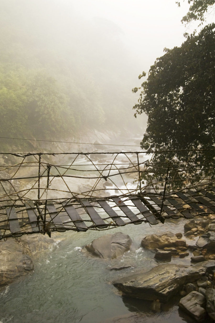 Rickety foot bridge in Northern Hilltribe trekking city of Moung Mon on the border of China (Sapa Region).