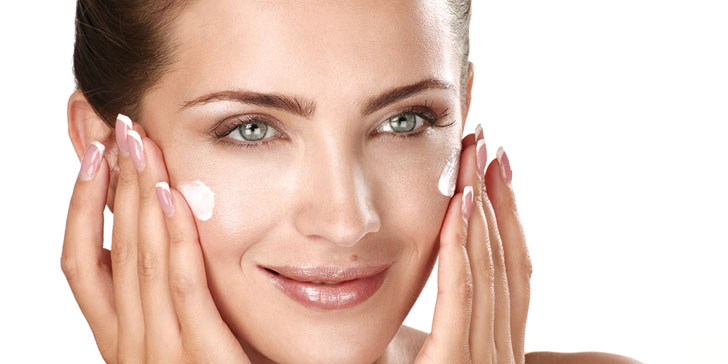 Beautiful Model Applying Cosmetic Cream Treatmen On Her Face