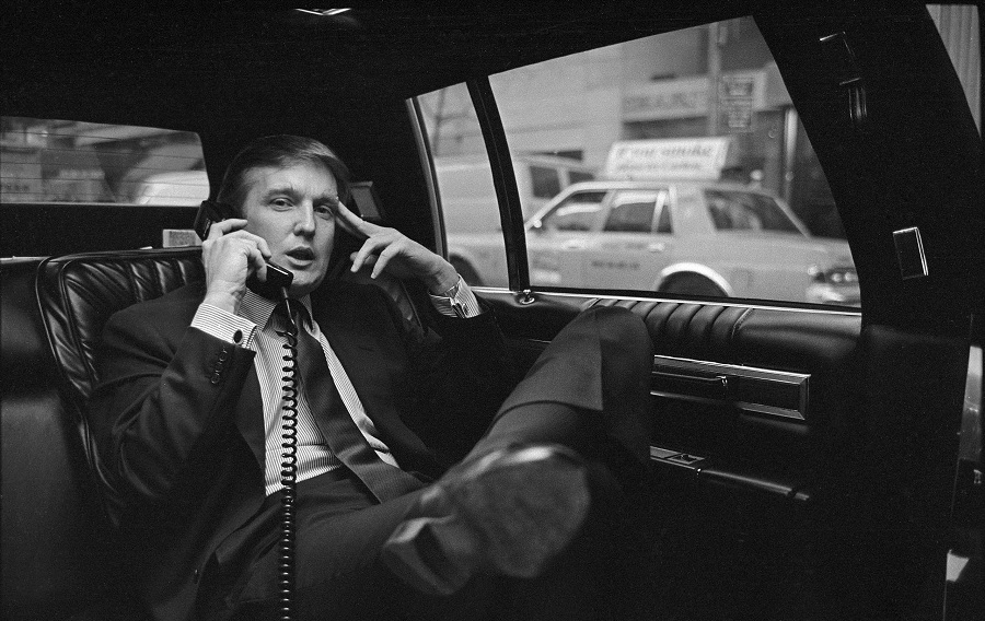 Donald Trump on the phone in his car after announcing plans for development of the west side of midtown Manhattan at the Hyatt Hotel on 42nd Street and Lexington Avenue, in New York, on Nov. 18, 1985.