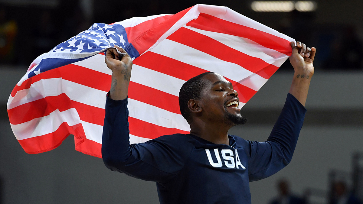 USA's guard Kevin Durant celebrates with USA's flag after defeating Serbia during a Men's Gold medal basketball match between Serbia and USA at the Carioca Arena 1 in Rio de Janeiro on August 21, 2016 during the Rio 2016 Olympic Games. / AFP / Andrej ISAKOVIC (Photo credit should read ANDREJ ISAKOVIC/AFP/Getty Images)
