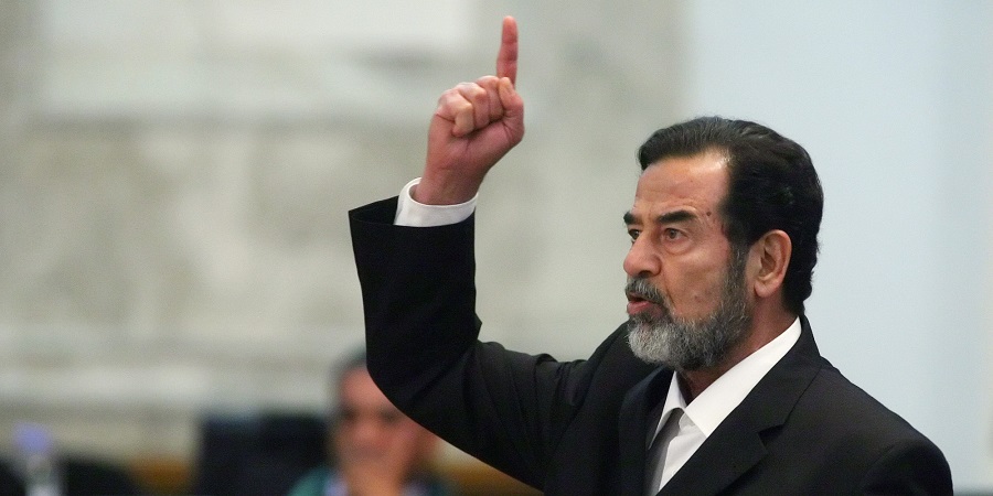 Former Iraqi president Saddam Hussein reacts as the verdict is delivered during his trial held under tight security in Baghdad's heavily fortified Green Zone, Sunday Nov. 5, 2006. Iraq's High Tribunal on Sunday found Saddam Hussein guilty of crimes against humanity and sentence him to die by hanging.    (AP Photo/Scott Nelson, Pool)
