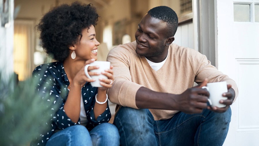 happy couple talking while drinking coffee iStock 882197436